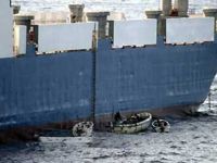 Sept. 28: Somali pirates in small boats are seen alongside the hijacked 'Faina.' (AP)