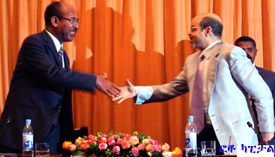 Hailu Shawel shaking hands with Meles Zenawi 