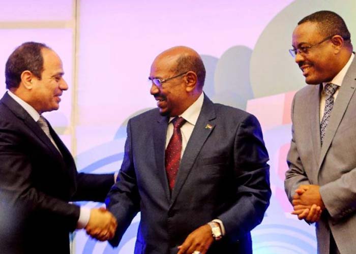 Sudanese President Omar al-Bashir, center, Egyptian President Abdel-Fattah el-Sissi, left, and Ethiopian Prime Minister Hailemariam Desalegn, right, shake hands after signing an agreement on sharing water from the Nile River, in Khartoum, Sudan, Monday, March 23, 2015. Egypt, Ethiopia and Sudan on Monday signed an initial agreement on sharing water from the Nile River that runs through the three countries, as Ethiopia constructs a massive new dam it hopes will help alleviate its electricity shortages. El-Sissi, al-Bashir and Desalegn welcomed the agreement in speeches in Khartoum’s Republican Palace on Monday. (AP Photo/Abd Raouf) (The Associated Press)