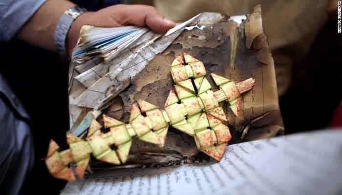 Security personnel bag a cross as evidence, Church bombing in Tanta, Egypt