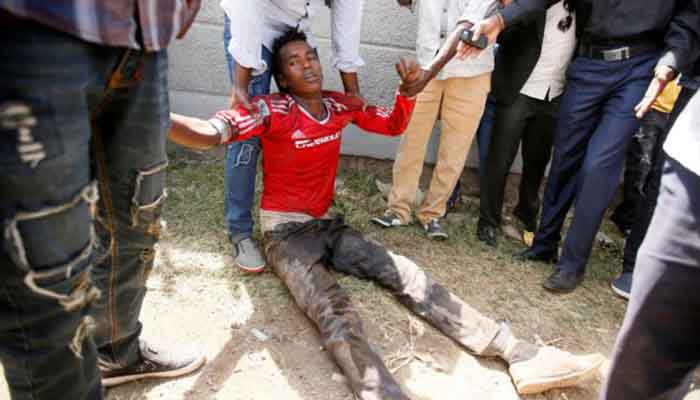 People assist an injured protester during Irrechaa, the thanks giving festival of the Oromo people in Bishoftu town of Oromia region, Ethiopia, October 2, 2016. People assist an injured protester during Irrechaa